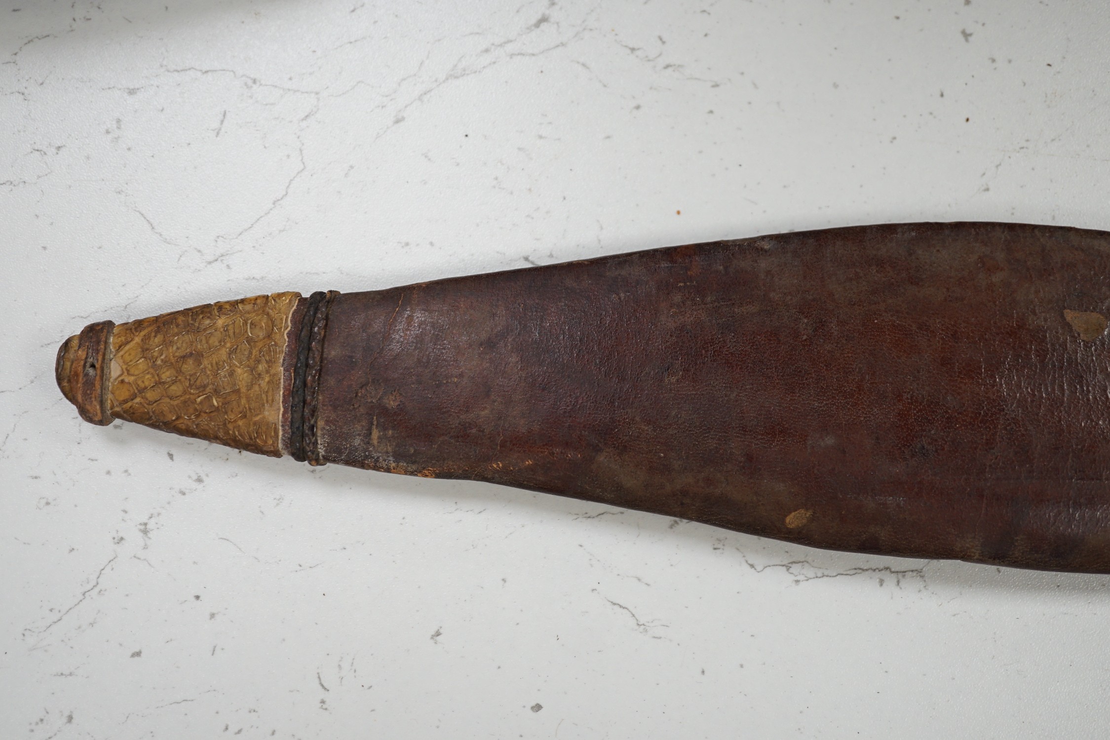 A Sudanese Kaskara sword with snake skin mounted leather scabbard, total length 79cm